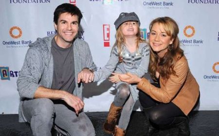 Megyn Price with husband, Edward Cotner, and daughter, Grace
